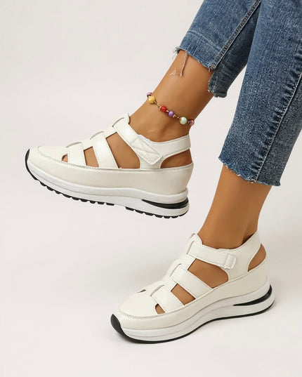 White cushioned platform sandals with multiple adjustable straps, front angle