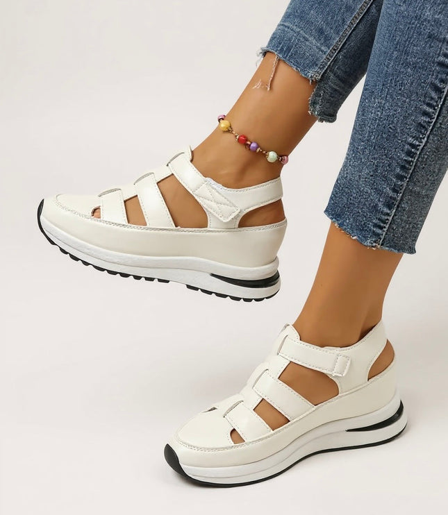 White cushioned platform sandals with multiple adjustable straps, front angle