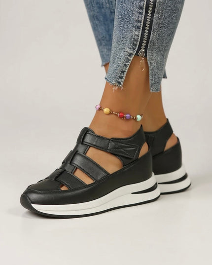 Black leather platform sandals with adjustable straps and white cushioned sole