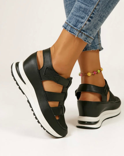 Black cushioned platform sandals with adjustable buckle straps, back angle