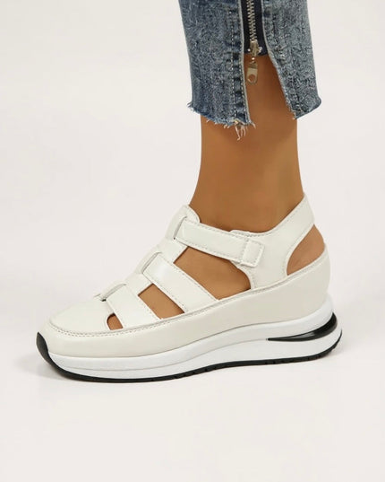 White cushioned platform sandals with adjustable straps, side view on foot