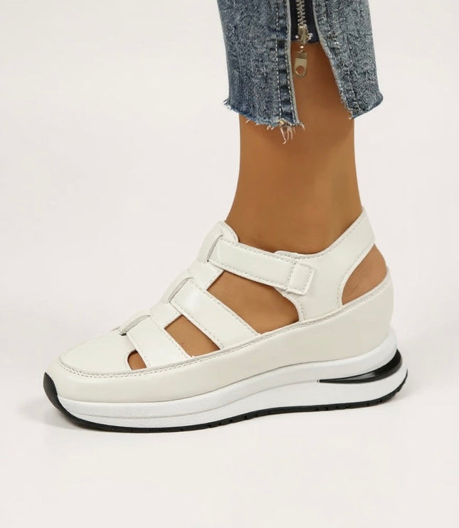 White cushioned platform sandals with adjustable straps, side view on foot