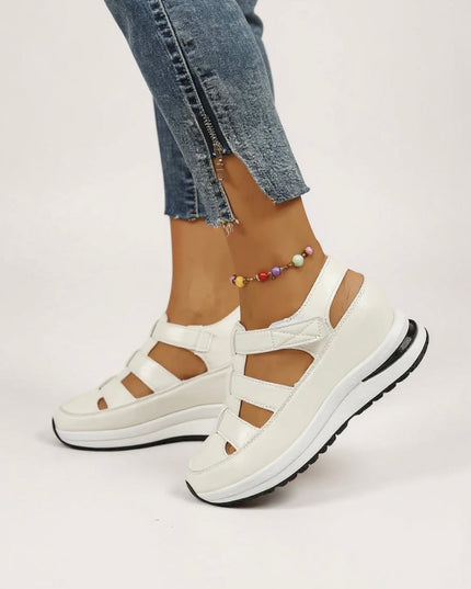 White platform sandals with multiple adjustable straps and cushioned sole, front view