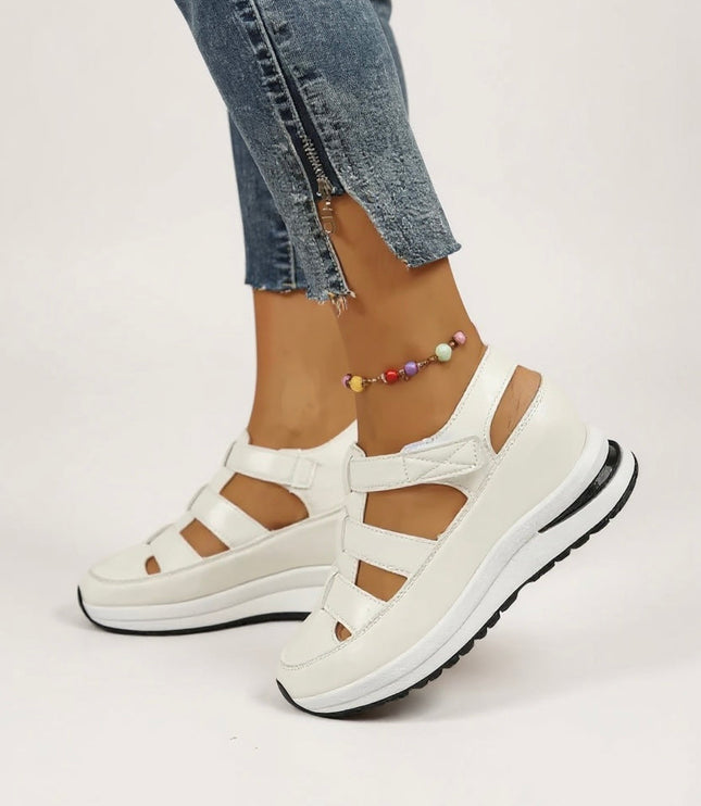 White platform sandals with multiple adjustable straps and cushioned sole, front view