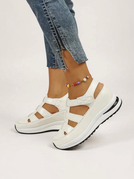 White platform sandals with multiple adjustable straps and cushioned sole, front view