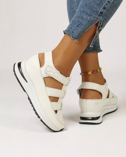 White platform sandals with adjustable straps and cushioned sole, side view