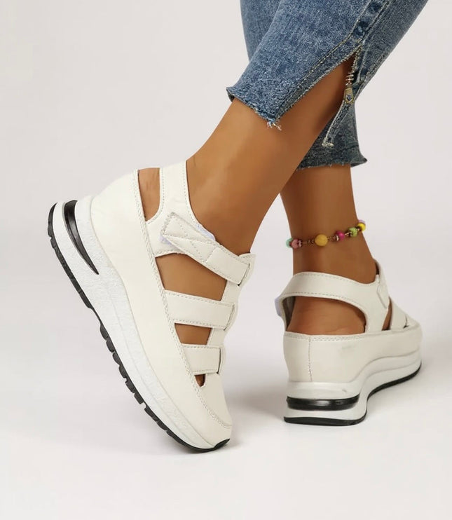 White platform sandals with adjustable straps and cushioned sole, side view