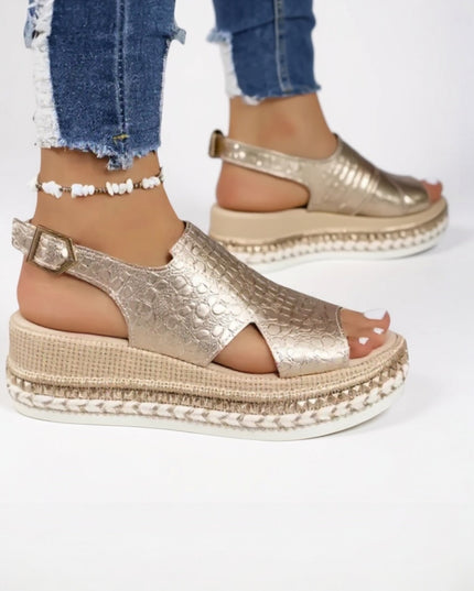 Gold metallic croc platform sandals worn with distressed jeans, peep toe detail visible