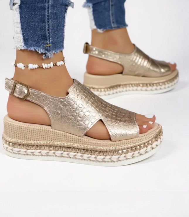 Gold metallic croc platform sandals worn with distressed jeans, peep toe detail visible