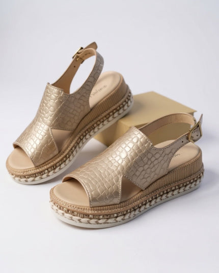 Two metallic gold croc platform sandals displayed, showing peep toe and ankle buckle