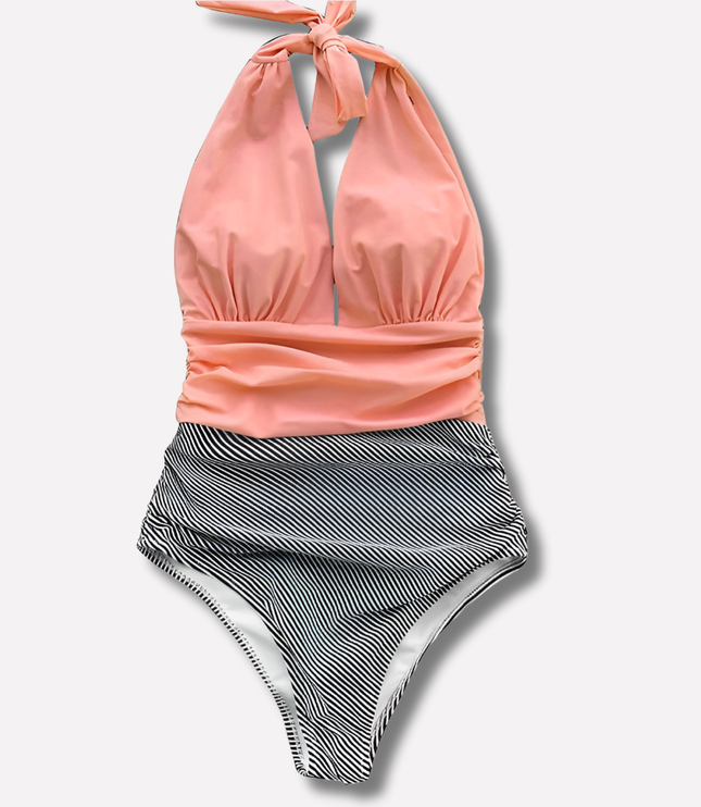 Coral halter swimsuit with black striped ruched high-waisted bottom, flat lay