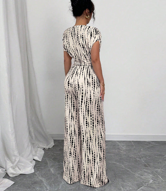 Back view of white wide-leg jumpsuit with black striped print and tie-waist detail