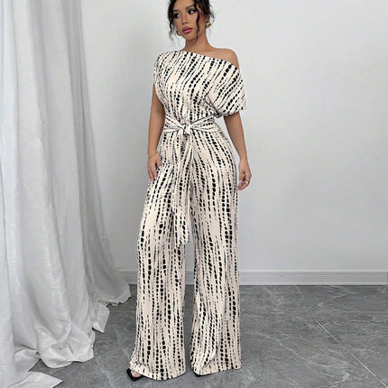 White jumpsuit with black dash print, off-shoulder neckline, short sleeves, wide-leg silhouette