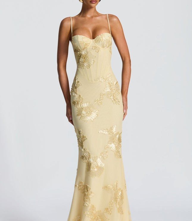 Sleeveless cream maxi dress featuring gold embroidered sunflower details
