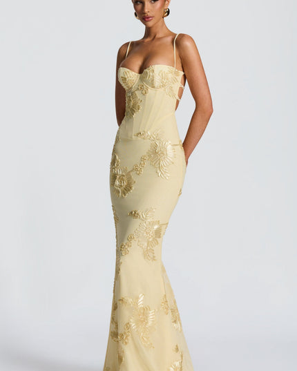 Fitted cream maxi dress with spaghetti straps and gold embroidered flowers