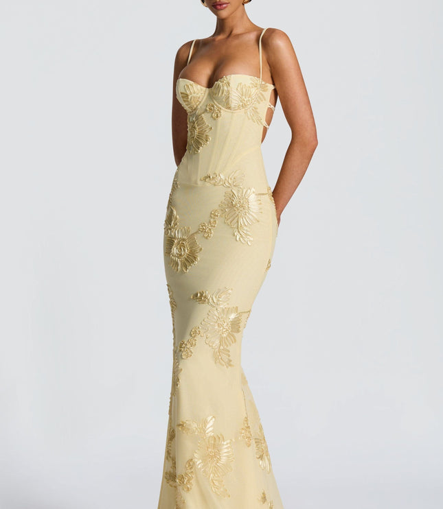 Fitted cream maxi dress with spaghetti straps and gold embroidered flowers