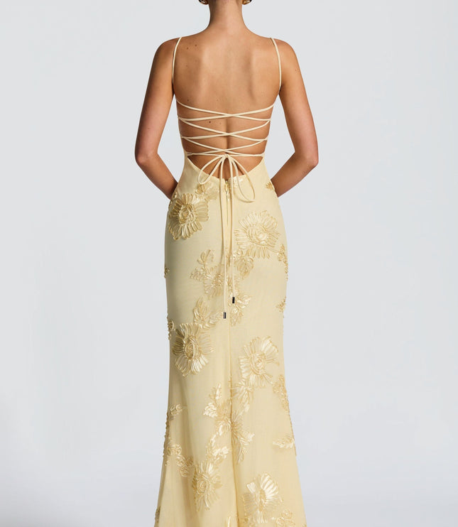 Back view of cream dress with crisscross lace-up straps and gold floral embroidery