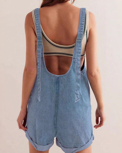 Back view of blue denim romper with large open back cutout detail