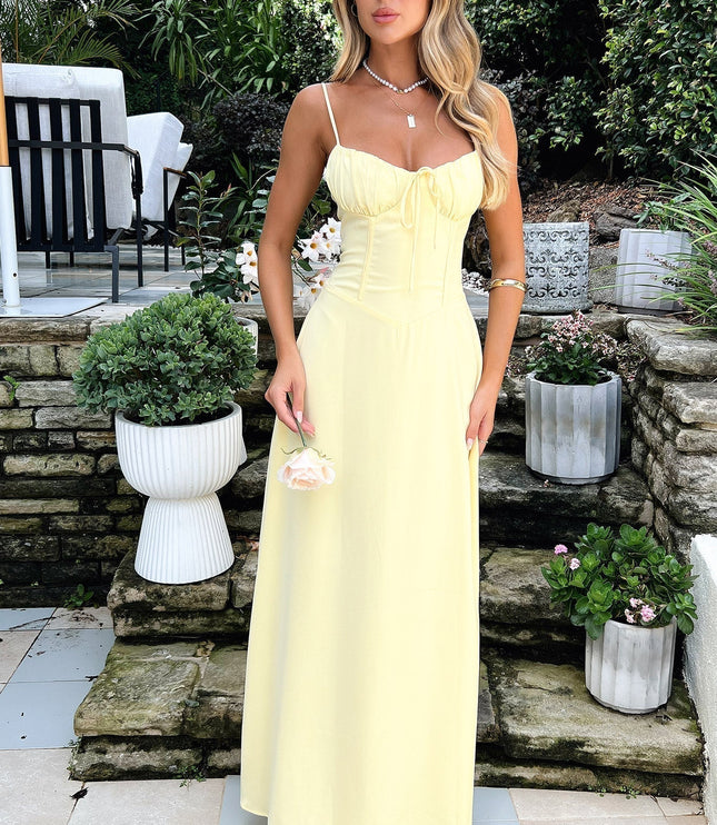 Front view of pale yellow maxi dress with sweetheart neckline and tie bow detail