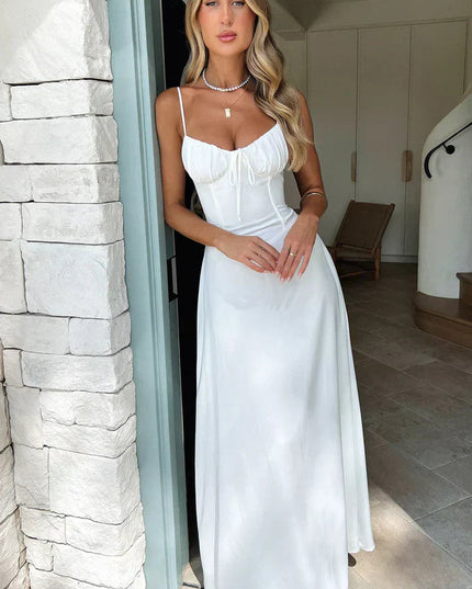 White maxi dress with sweetheart neckline, tie bow detail, and spaghetti straps