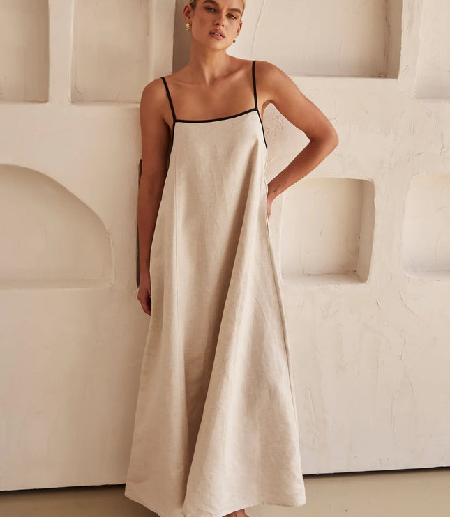 Cream linen maxi dress with thin black straps and relaxed A-line fit