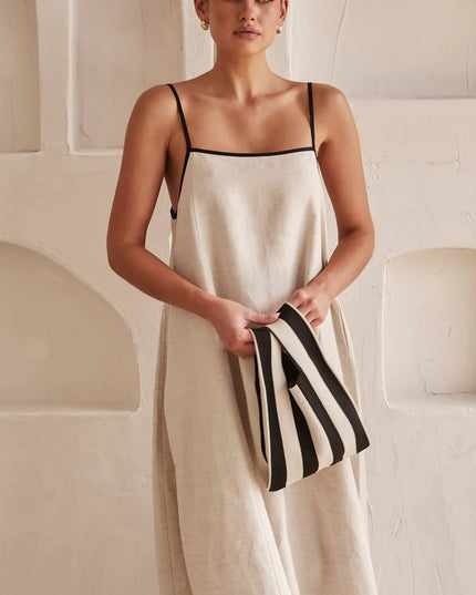 Front view of cream summer maxi dress with square neckline and black trim
