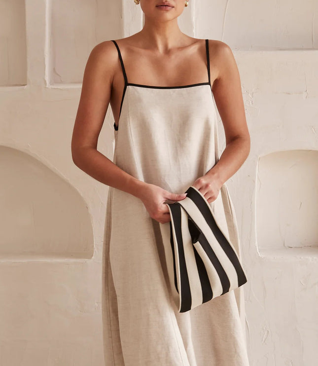 Front view of cream summer maxi dress with square neckline and black trim