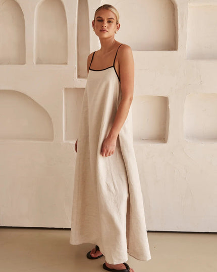Side profile of cream summer maxi dress with thin black shoulder straps