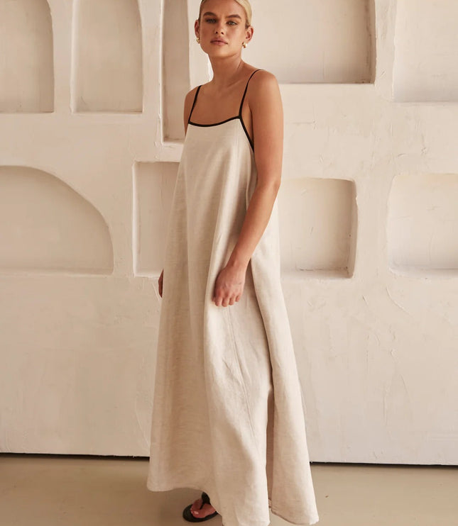 Side profile of cream summer maxi dress with thin black shoulder straps