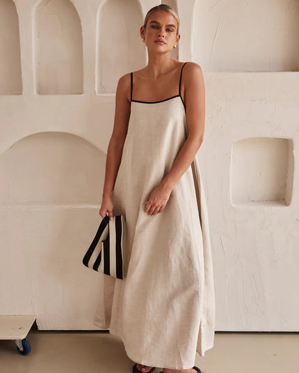 Cream spaghetti strap maxi dress with black trim and flowing silhouette