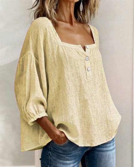 Lightweight cream top featuring square neck, puff sleeves, and front button closure detail