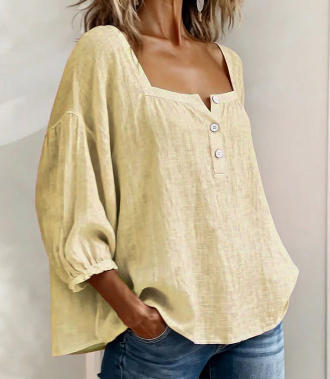 Lightweight cream top featuring square neck, puff sleeves, and front button closure detail