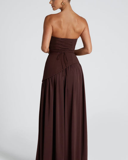 Back view of brown strapless maxi dress with ruched bodice and asymmetrical hem