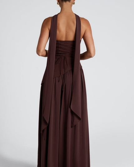 Back detail of brown asymmetrical maxi dress with flowing fabric and choker strap