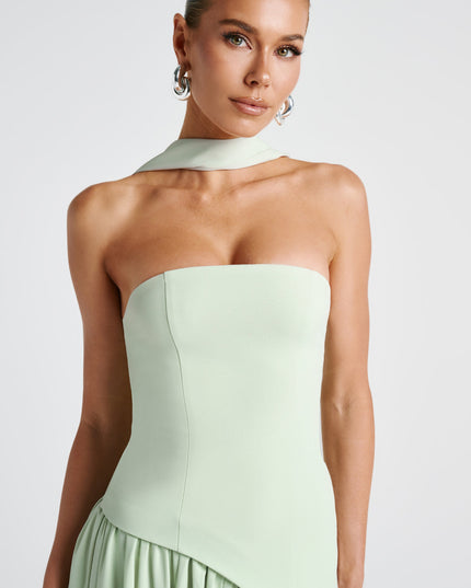 Close-up back view of sage green asymmetrical maxi dress with ruched bodice
