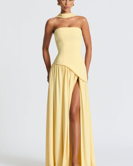 Soft yellow strapless maxi dress with asymmetrical pleated skirt and choker neckline