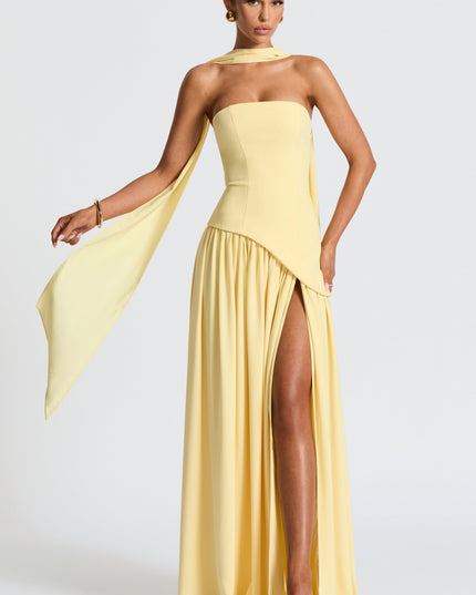 Yellow strapless maxi dress with flowing asymmetrical hem and draped sleeve detail