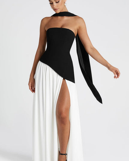 Side view of strapless black and white maxi dress with flowing skirt