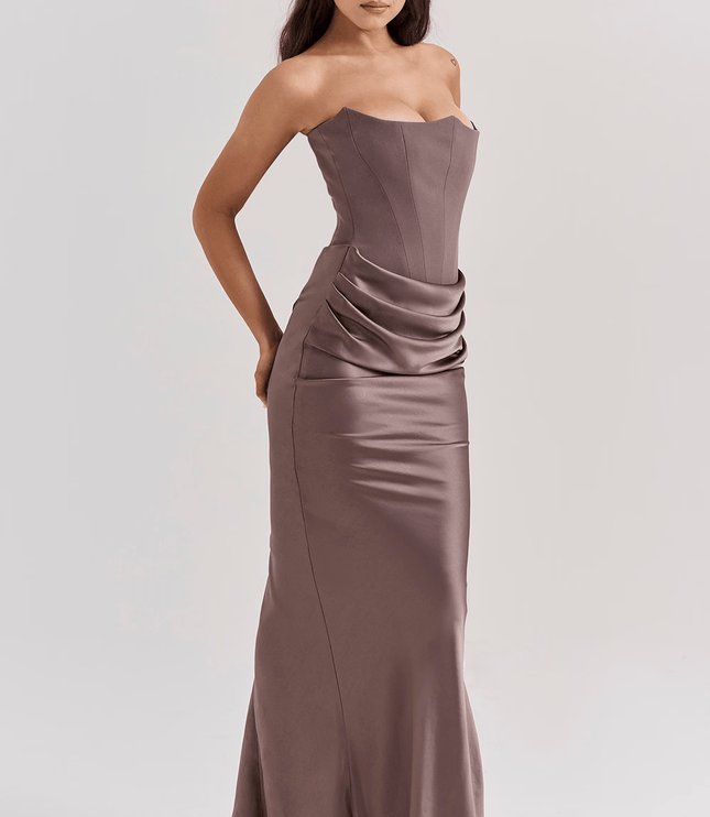 Side view of a women's taupe strapless maxi dress featuring a sweetheart neckline and elegant draped skirt.
