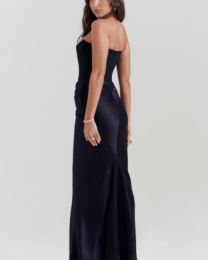 Side back view of a women's black strapless maxi dress, showing the sleek fit and subtle train.