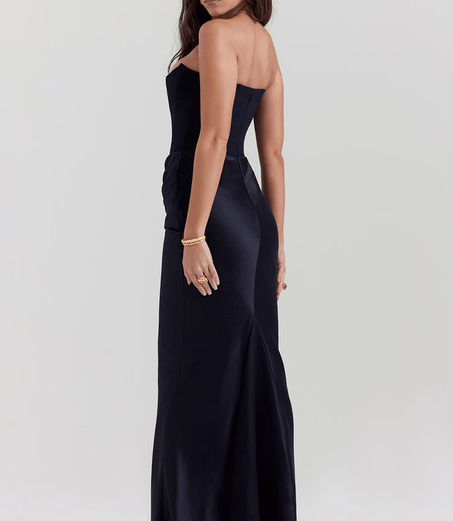 Side back view of a women's black strapless maxi dress, showing the sleek fit and subtle train.