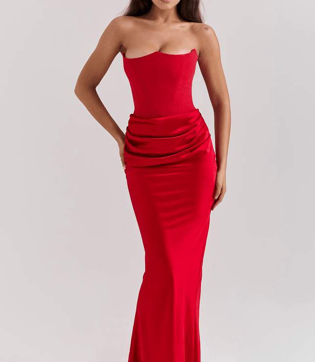Full-length view of a vibrant red strapless sweetheart corset maxi dress for women, with a draped waist.