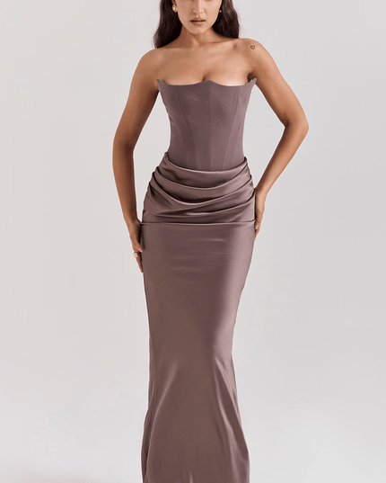 Full-length view of a women's strapless sweetheart corset maxi dress in a muted taupe color with draped waist detail.