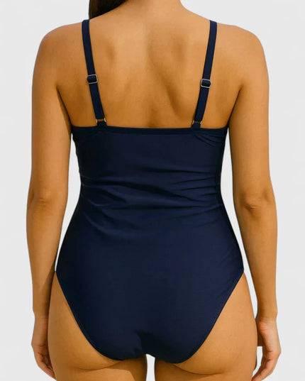 Back view of navy one-piece swimsuit with adjustable straps and ruched sides