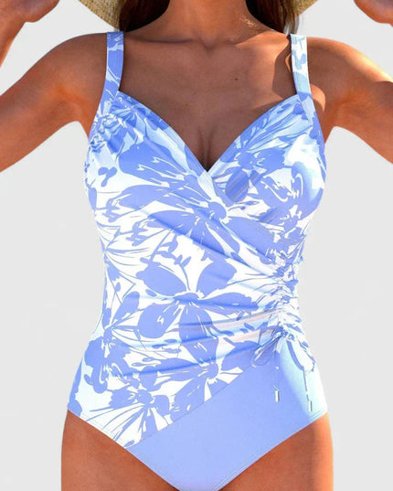 Blue and white floral print wrap-front one-piece with ruched sides