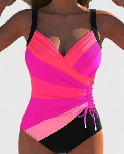 pink and magenta wrap-front one-piece swimsuit with black bottom