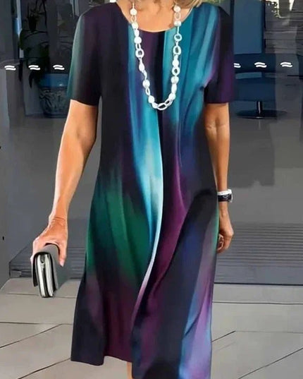 Front view of dark abstract print midi dress with blue and purple streaks, short sleeve women’s dress
