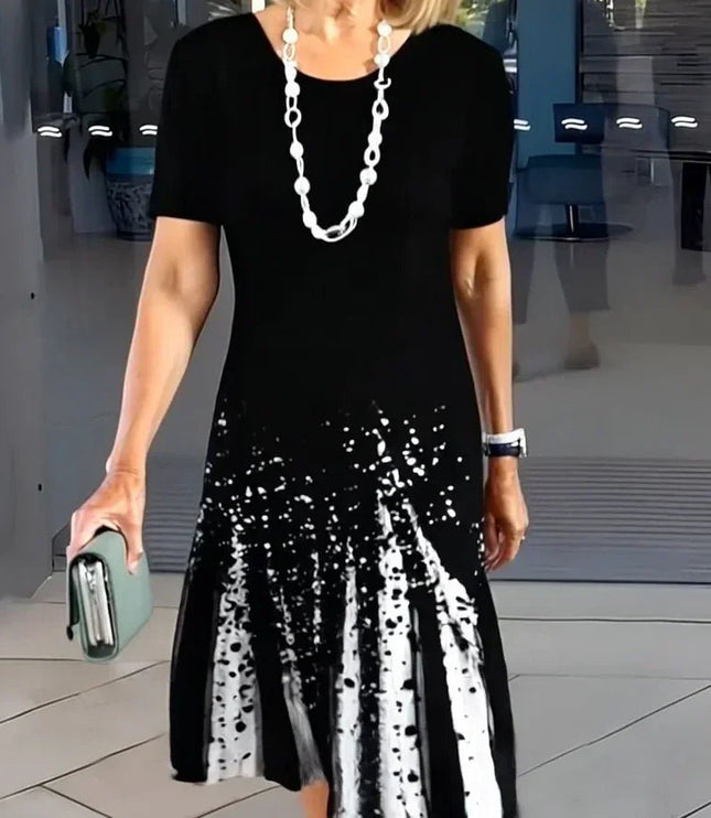 Black midi dress with white abstract splatter print and short sleeves, casual women’s t shirt dress