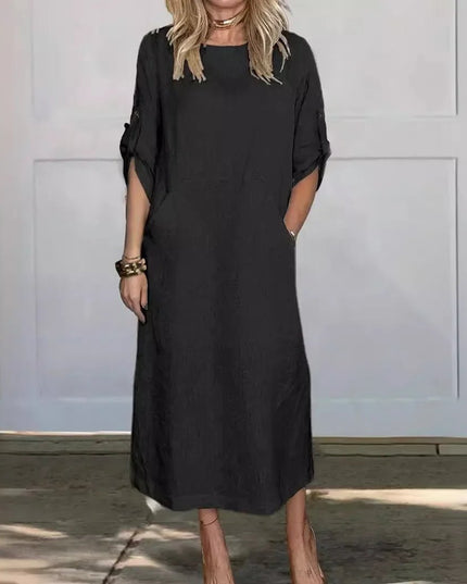 Black summer midi dress with pockets, rolled sleeves, and loose casual silhouette