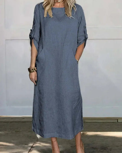 Blue-gray midi dress with pockets, rolled sleeves, and lightweight summer style